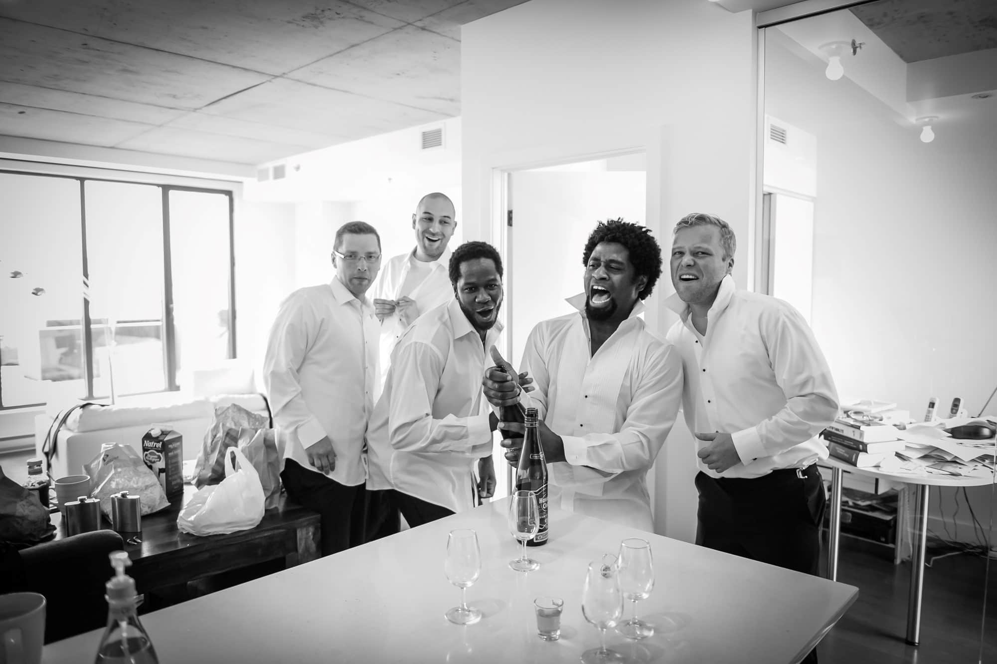 eric popping champagne groomsmen getting ready condo iberville trendy excited